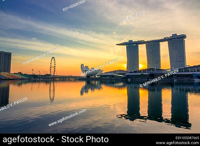Singapore. The main concentration of attractions - Marina Bay. Morning with sunrise behind the hotel