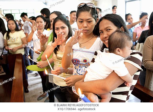 Lapu-Lapu City, Philippines, 26/02/2012: 200-300 babies being baptised in a single 3 hour ceremony at Mactan Air Base Chapel
