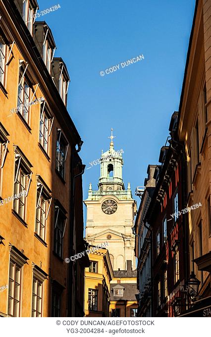 Tower from Church of St. Nicholas - Storkyrkan - Stockholm Cathedral rises between buildings, Gamla Stan - old town, Stockholm, Sweden