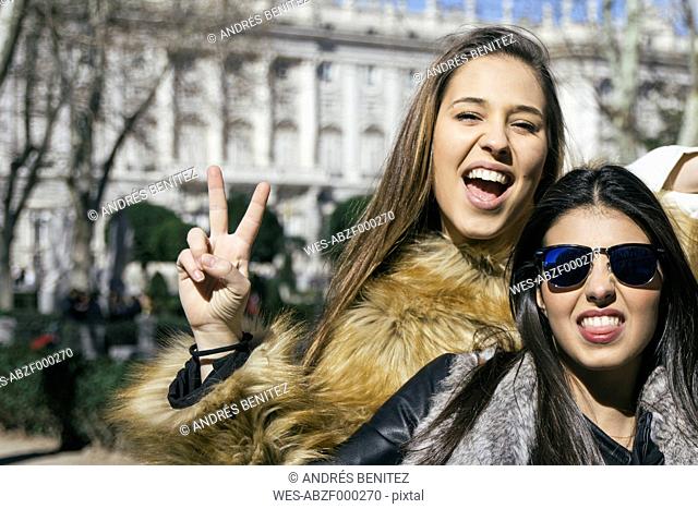 Spain, Madrid, two women posing in front of royal palace