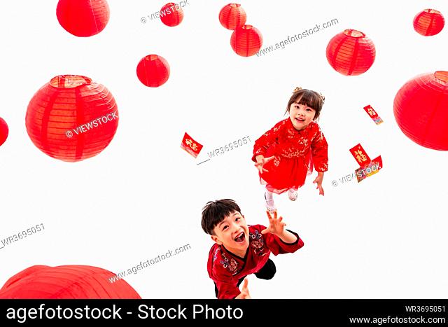 Boys and girls hand pick up a red envelope under red lanterns