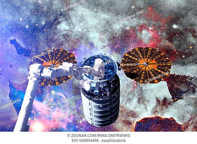 Cargo spacecraft - The Automated Transfer Vehicle over spiral galaxy. Elements of this image furnished by NASA