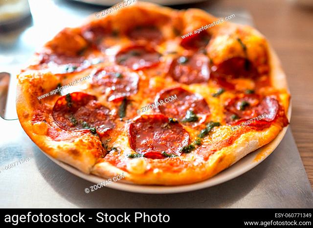 Pepperoni pizza on a plate on the table