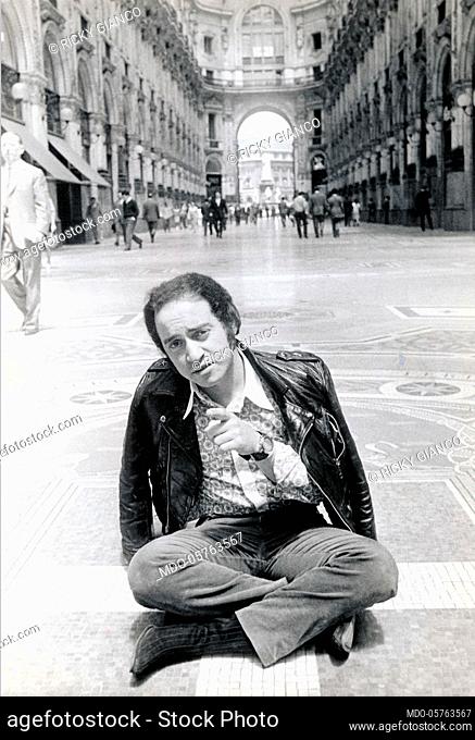 Italian singer Ricky Gianco (Riccardo Sanna) sitting in the Galleria Vittorio Emanuele II. Milan, 1960s
