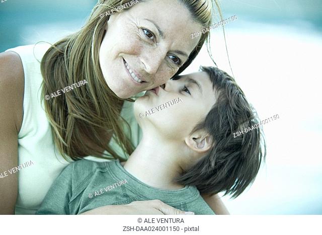 Boy and mother, boy kissing woman's cheek