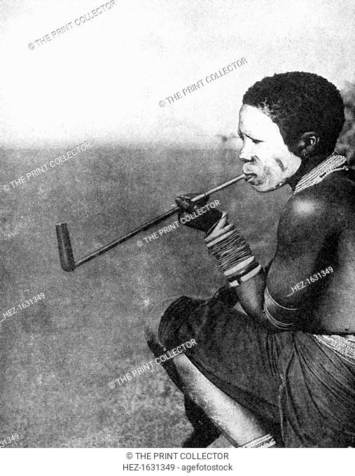 A South African native smoking, 1936. From Peoples of the World in Pictures, edited by Harold Wheeler, published by Odhams Press Ltd (London, 1936)