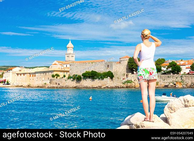 Lady viewing at famous touristic Krk town on Krk island, Croatia, Europe