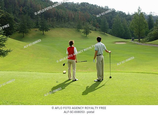 Couple looking down the fairway from the tee ground
