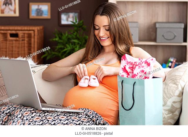 Future mother doing online shopping at home. Debica, Poland