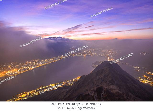 Colored clouds and fog during twilight on the Garlate Lake from Monte Barro, Monte Barro Regional Park, Brianza, Lombardy, Italy, Europe