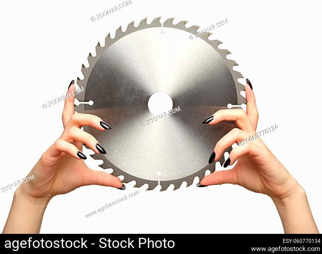 Female hands with black nails manicure with circular saw blade. Isolated on white background