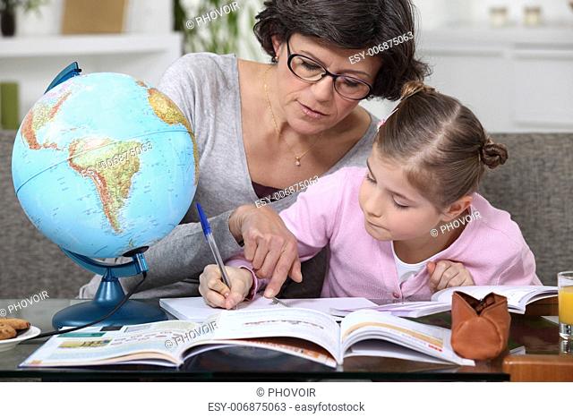 Mother teaching daughter geography