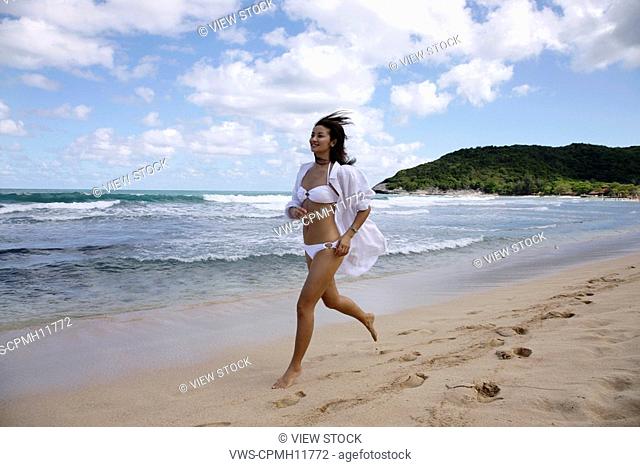 Chinese Young Woman Running On The Beach, America