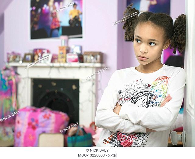 Young Girl leaning against door arms crossed Showing Attitude