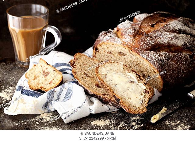 Rice bread with dates, spread with butter, and coffee in a glass