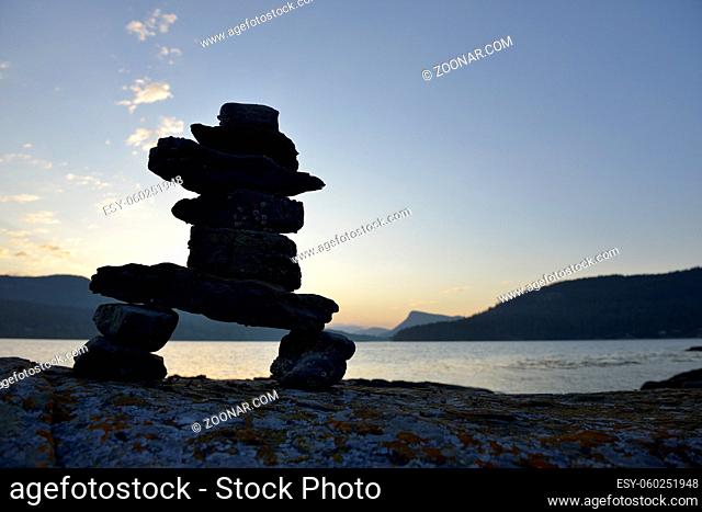 Rock inukshuk in front of Salt Spring Island, Russell Island, British Columbia, Canada