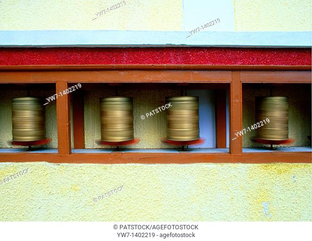 A prayer wheel is a 'wheel' on a spindle made from metal, wood, leather, or even coarse cotton  On the wheel are depicted or encapsulated prayers