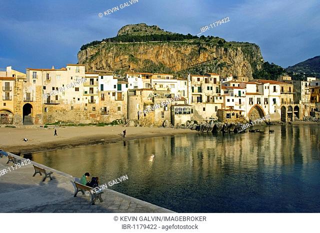 Old port Mt. La Rocca, young couple, moorish architecture town of Cefalu, Province of Palermo, Sicily, Italy