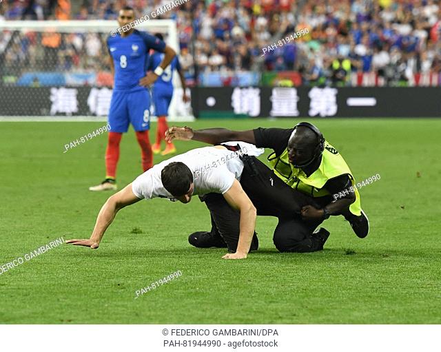 A pitch invader is catched by a steward during during the UEFA EURO 2016 soccer Final match between Portugal and France at the Stade de France, Saint-Denis