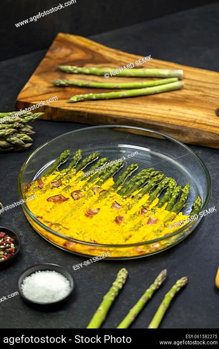 green asparagus baked with chedar cheese and parma ham