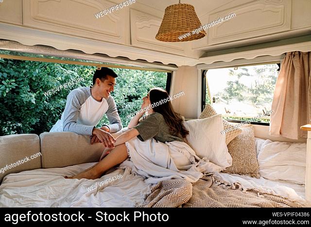 Loving young couple looking at each other through motor home window