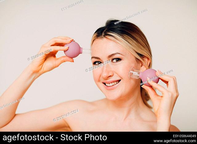 Cupping therapy procedure, woman with little medical cup for face