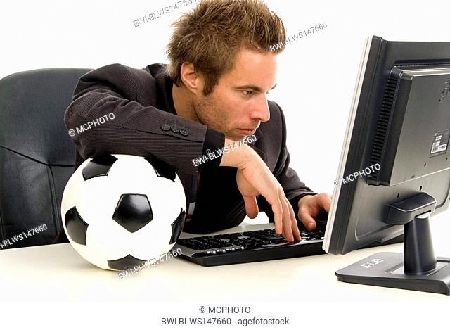 business man with football in office