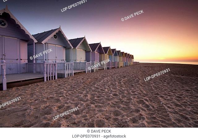 England, Essex, Mersea Island, Early dawn over new beach huts on Mersea Island