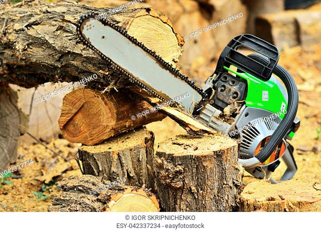 The durable chainsaw lies on the stump