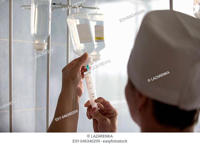 Belarus, Gomel, 24 April 2018. The Gomel Central Hospital.A nurse is preparing medical droppers.A nurse with a syringe makes a dropper