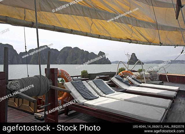 Large comfortable sailing junk with aft deck sun beds Halong Bay Vietnam