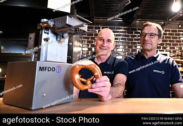 PRODUCTION - 02 February 2023, Baden-Württemberg, Stuttgart: Dieter Obertautsch (l) and Michael Feil (r), the inventors and developers of a butter pretzel...