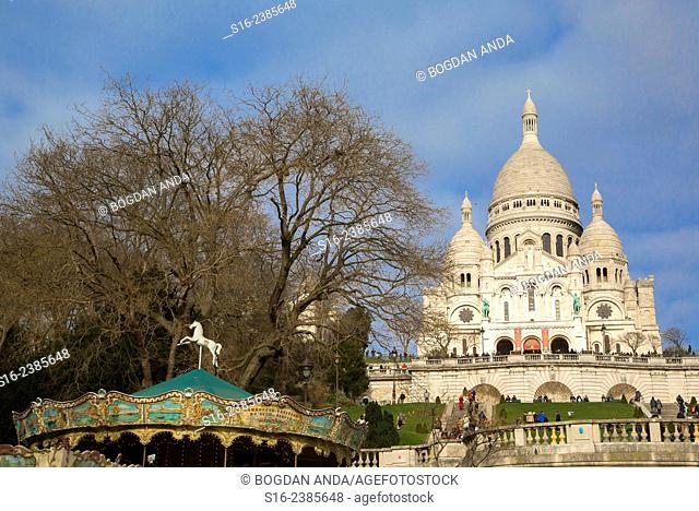 Paris, France - Merry Go Round in front of Sacre-Coeur Basilica, in Montmartre