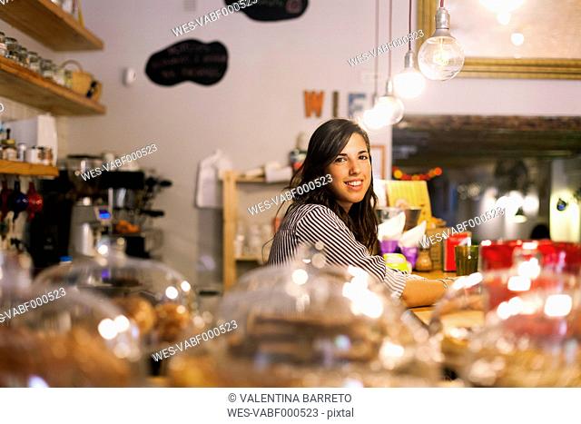 Young woman working in her own little cafe