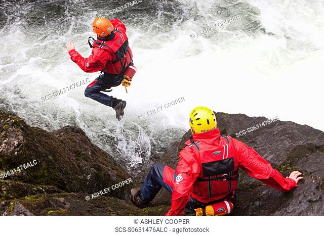 Members of the Langdale/Ambleside Mountain Rescue Team train in Swift water rescue techniques on the River Brathay at Skelwyth, Lake District, UK