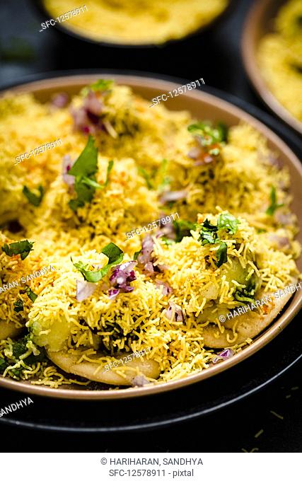 Sev puri (Indian snack made form potatoes, onions and chutney)