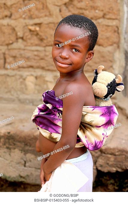 African girl with a cuddy toy. Togo