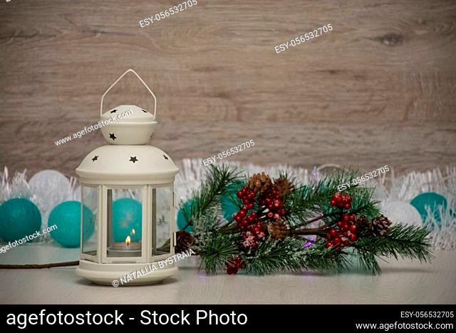 textured wooden board as a background for text space, decorated with Christmas lights and a garland, and pine cone
