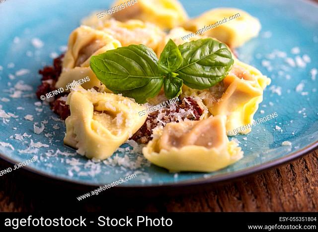 tortellini with olive oil on a blue plate