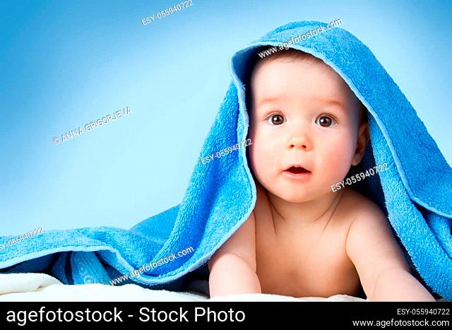 Cute eight month old baby wrapped in a towel