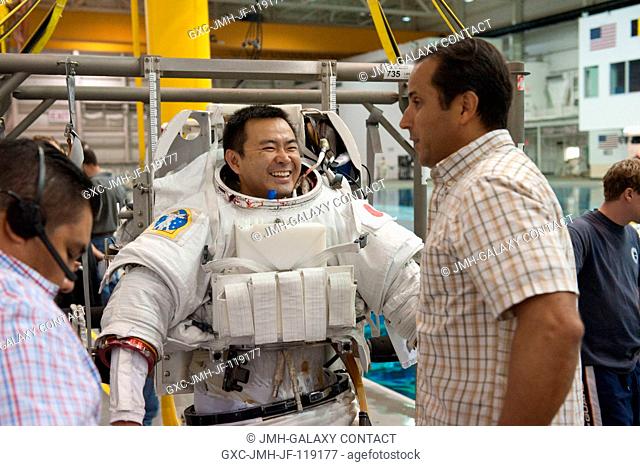 Japan Aerospace Exploration Agency (JAXA) astronaut Akihiko Hoshide, Expedition 3233 flight engineer, attired in a training version of his Extravehicular...