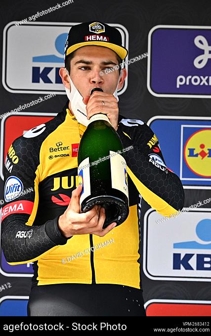 Belgian Wout Van Aert of Team Jumbo-Visma celebrates on the podium with champagne after winning the Gent-Wevelgem - In Flanders Fields cycling race