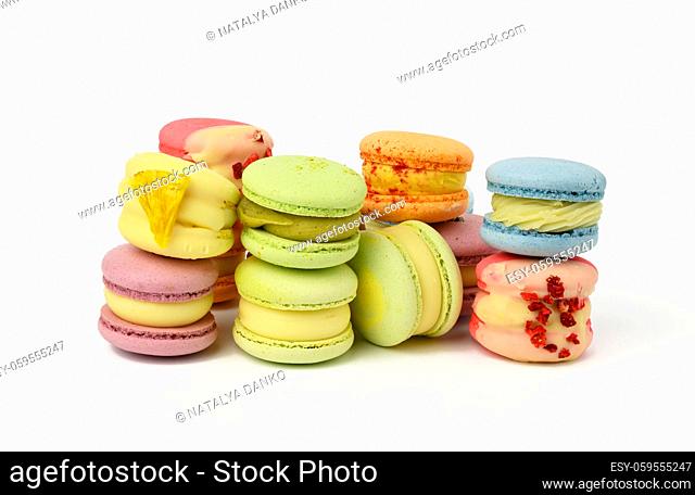 baked red macarons and red rosebuds on a white background, gourmet almond flour dessert