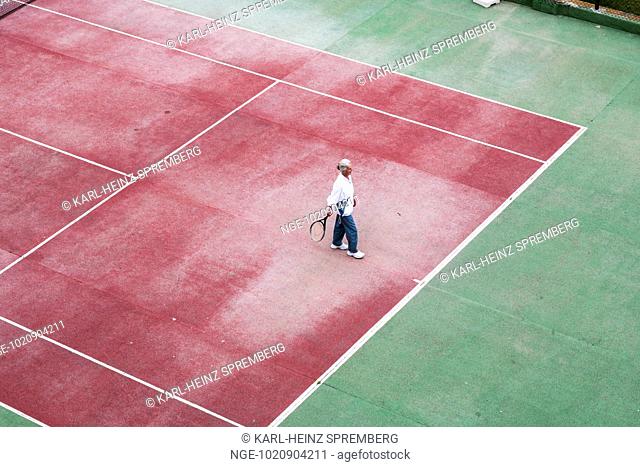 Senior citizen keeps fit with tennis