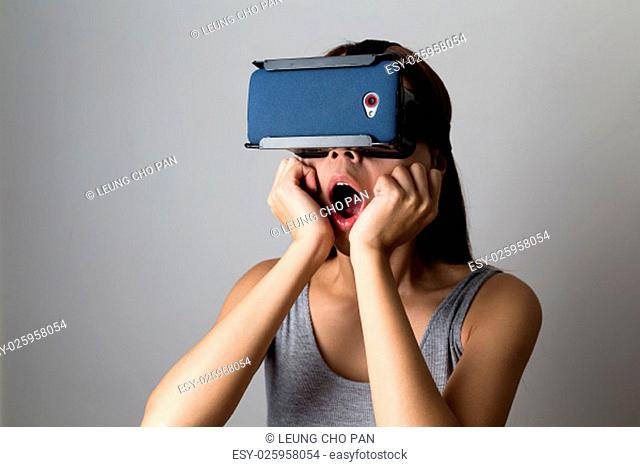Young Woman feeling shocking for using the virtual reality device