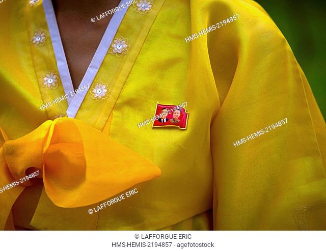 North Korea, South Hamgyong Province, Hamhung, close-up of the dear leaders badge on the traditional dress of a north korean woman