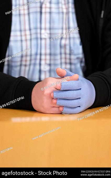28 September 2022, Baden-Württemberg, Rottweil: The 38-year-old accused sits in the courtroom before the trial begins, wearing a glove on his left hand