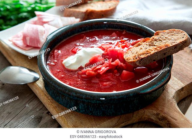 Ukrainian and russian national red soup borsch. Beetroot soup on wooden background/