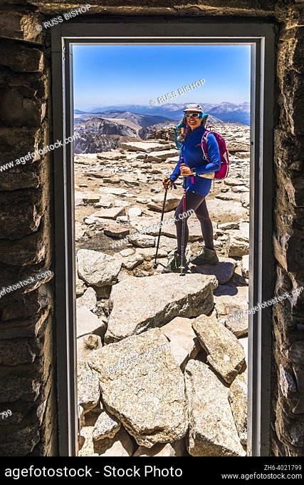 Hiker from inside the summit hut on Mount Whitney, Sequoia National Park, California USA