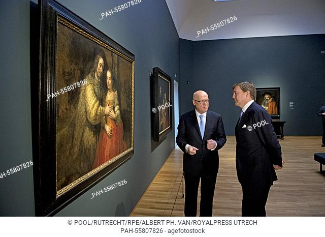 Dutch King Willem Alexander (R) poses besides the painting 'Self Portrait with two circles' of Dutch painter Rembrandt (1665